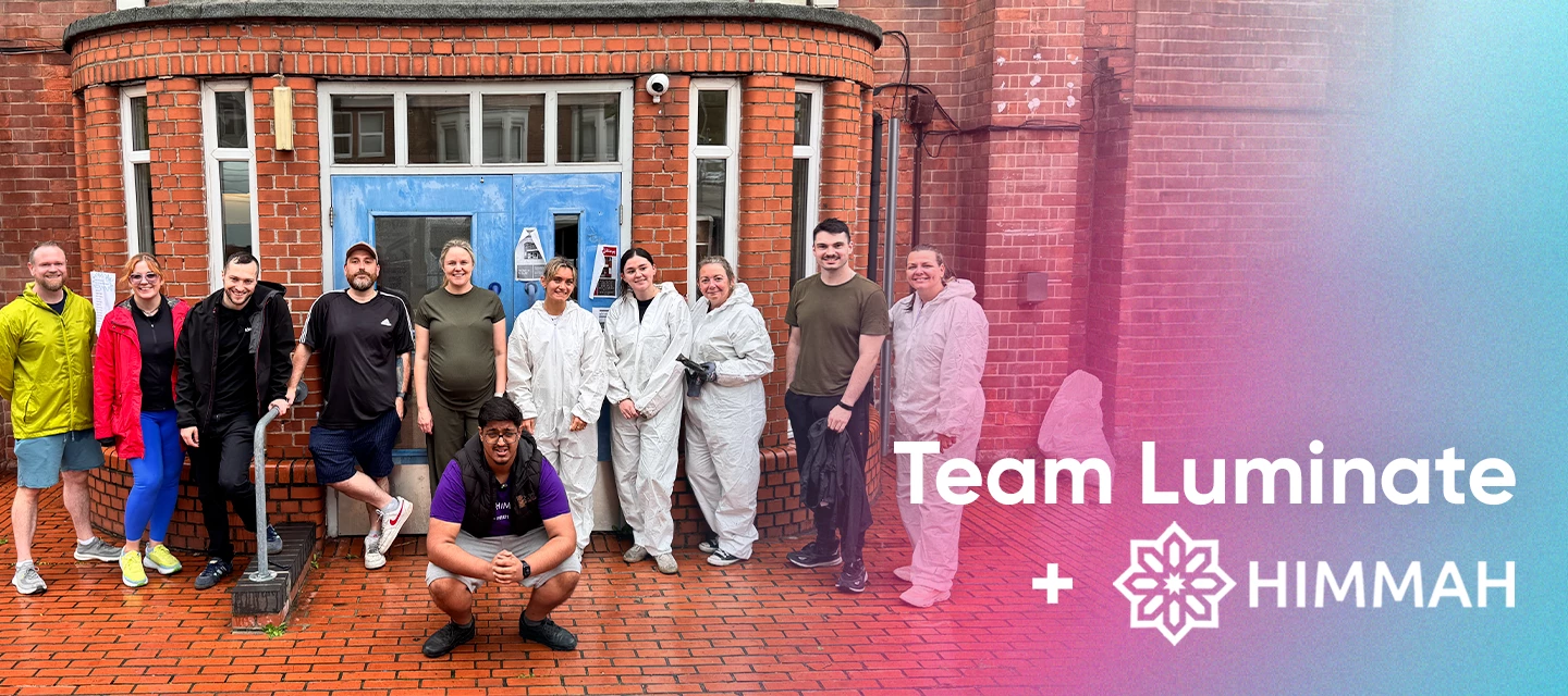 The Luminate team standing at the Himmah Hub building with the text overlay "Team Luminate and Himmah"