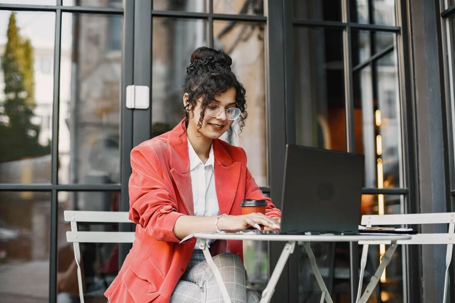 indian-woman-working-laptop-street-cafe-wearing-stylish-smart-clothes-jacket-glasses (1).jpg